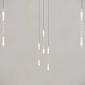Multiple Modern Glass Chandeliers Hanging From Ceiling With Warm Light And Minimalist Design