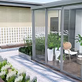 Modern Outdoor Glass Corridor With Landscaped Plants And Paved Walkway