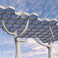 Modern Architectural Structure With Tree Like Columns And Hexagonal Honeycomb Roof Against Blue Sky Background
