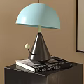 Light Blue Shade Table Lamp With Dark Brown Cone Base On Black Table With Book 3d model