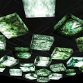 Cube Shaped Lightboxes With Green And White Textured Design Hanging From Black Background Ceiling
