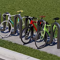 Colored Bicycles Parked at Black U Bicycle Rack on Green Grass and Concrete Pavement