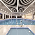 Modern Indoor Swimming Pool Interior Design With Stylish Ceiling Lighting And Poolside Lounge Chairs
