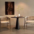 Modern Round Table With Woven Chairs Dark Wooden Painting And Vase Plant On Floor