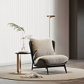 Minimalist Single Sofa With Soft Pillow Beside Gold Side Table Floor Lamp On Round Rug