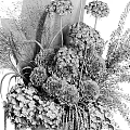 Elegant Decorative Ornament Arrangement With Lush Green Foliage White Flowers And Spherical Plants