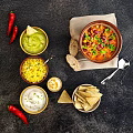 Fresh Homemade Mexican Food with Guacamole Corn Salad Sour Cream Tortilla Chips and Chili Stew