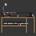 Weapon Assembly Process On Wooden Workbench With Tools Laptop Lamp And Paints
