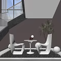 White Modern Chairs And Round Table Setup With Red Bottle Green Plant Black Pebble Floor