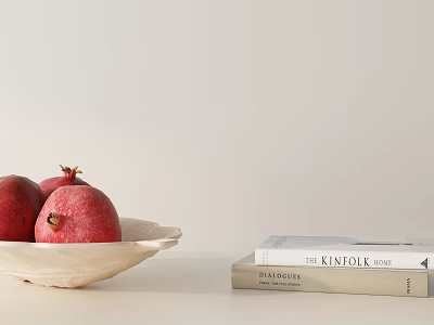 Fresh Ripe Pomegranates in White Bowl with KINFOLK and BRIDES Books 3d model