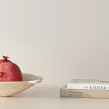 Fresh Ripe Pomegranates in White Bowl with KINFOLK and BRIDES Books