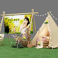 Outdoor Promotional Booth with Tent Billboard Windmill and Flower Decorations on Green Grass