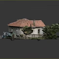 Small House Model With Red Roof White Walls And Surrounding Green Plants