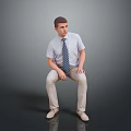 Man Sitting On Dark Surface Wearing Light Blue Shirt Striped Tie And Khaki Pants