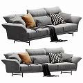 Gray Velvet Three Seater Sofa With Orange Checkered Pillows And Black Blanket