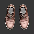 Tan Leather Brogue Ankle Boots With Intricate Lace Up Design On Reflective Surface