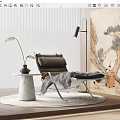 Modern Leather Lounge Chair With Marble Side Table Plant Plush Rug And Wall Art
