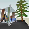 Transparent Glass Structure With Wheels Nearby Tree And Person Walking Inside
