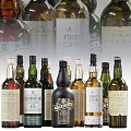 Assorted Whisky Bottles and Glasses in Different Colors with Brand Labels