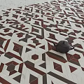 Geometric Patterned Background Wall With Red Brown White Tiles And Decorative Teapot