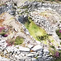 Ancient Stone Ruins With Circular Walls Green Grass And Purple Flowers