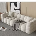 White Sectional Sofa with Plush Cube Design Cushions Striped Throw Blanket and Abstract Wall Art