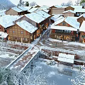 Winter Scenery Of Snow Covered Traditional Wooden Houses Village With Small Bridge River And Trees