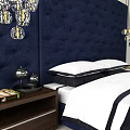Elegant Double Bed With Navy Tufted Headboard Pendant Lights Nightstands And Bed Linens