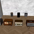 Multiple Vintage Headphones and Speakers Arranged on Wooden Floor with Gray Wall and Lighting