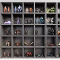Organized Display Shelf Showcasing Various Collectible Action Figures And Models