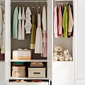 Neatly Arranged Clothes In Wardrobe With Hanging Garments Folded Items Storage Boxes And Teddy Bears