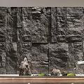 Serene Courtyard Garden With Natural Stone Wall Deer Ornament And Lush Plants