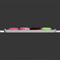 Colorful Donuts With Various Icing Colors And Sprinkles On Transparent Tray
