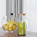 Transparent Glass Bowl With Yellow Fruits And Glass Jug Of Green Liquid On Wooden Tabletop