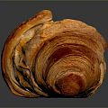 Golden Flaky Freshly Baked Croissant With Crispy Layers On Dark Reflective Surface