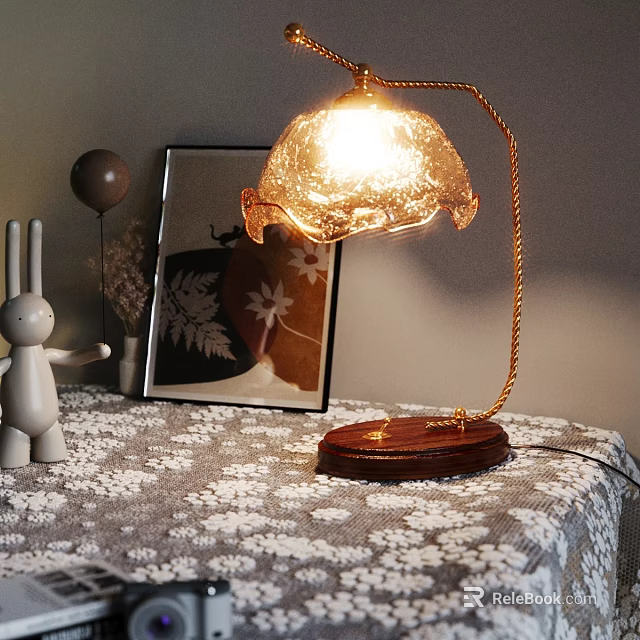 Lit Table Lamp With Wooden Base Gold Stand Transparent Shade On Patterned Tablecloth 3d model 