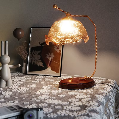 Lit Table Lamp With Wooden Base Gold Stand Transparent Shade On Patterned Tablecloth 3d model