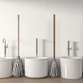 Three White Washbasins With Faucets And Mops On Wooden Handles Arranged In Row