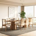 Modern Restaurant Dining Area With Round Wooden Table Rattan Chairs Abstract Painting And Green Plant