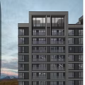 Modern High Rise Residential Building With Large Windows And Balconies Overlooking City View