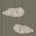 Two Cloud Shaped Pendant Lights With Warm Yellow Glow For Indoor Ambiance Design