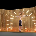 YY2021 Annual Ceremony Scene With Golden Tassel Backdrop Woman In Black Dress And Decorative Balls