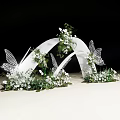 White Curved Wedding Arch With Butterfly Decorations White Flowers And Greenery