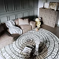 Modern Living Room With Green Paneled Walls Chandelier Beige Sofa Gray Armchair And Round Rug
