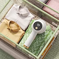 Transparent Drawer with Folded White Yellow Shirts Green Sweater and Handheld Garment Steamer Display 100