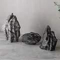 Natural Stone And Wooden Decor Pieces With Green Plant In Gray Interior