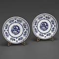 Blue and White Ceramic Plates Featuring Dragon Motifs and Patterns on Display Stands