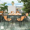 Cozy Villa Balcony With White Parasol Wooden Tables Chairs Green Plants And Brick Wall