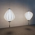 White Lantern Shaped Chandeliers With Striped Design And Tassels Against Gray Wall Interior