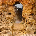 Scenic Rocky Cave Formation With Pathway And Arch